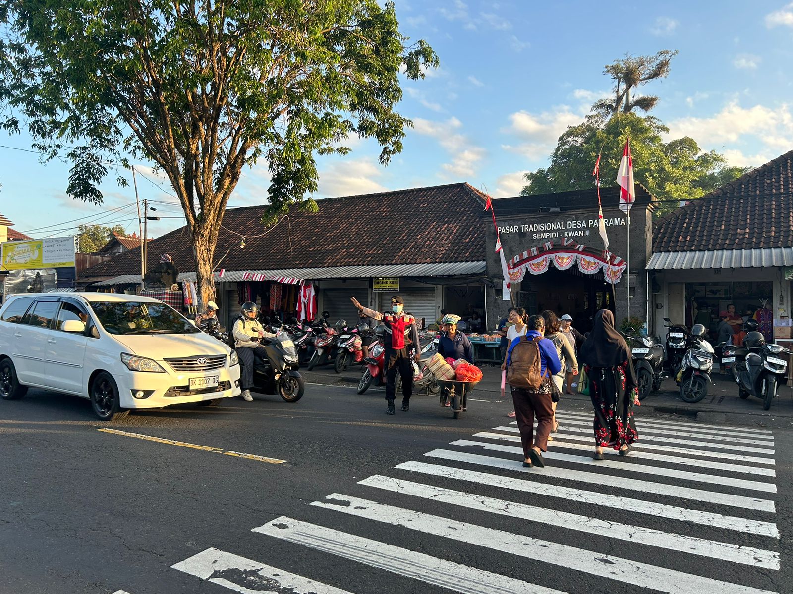 Berikan Rasa Aman Bripda Surya Putra Seberangkan Pejalan Kaki di Jalur Padat